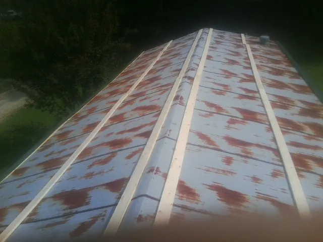 Rusted metal roof panels with new wood purlins before replacement — Storm Damage Roof Repair in Eagleville by Roofing Brothers